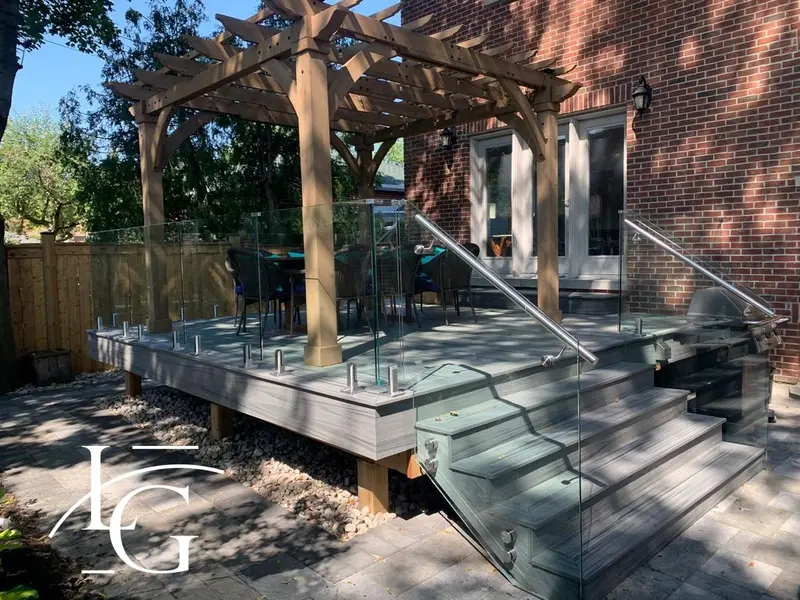Spigot-mounted frameless glass deck railing under a pergola, 12 mm — Oakville