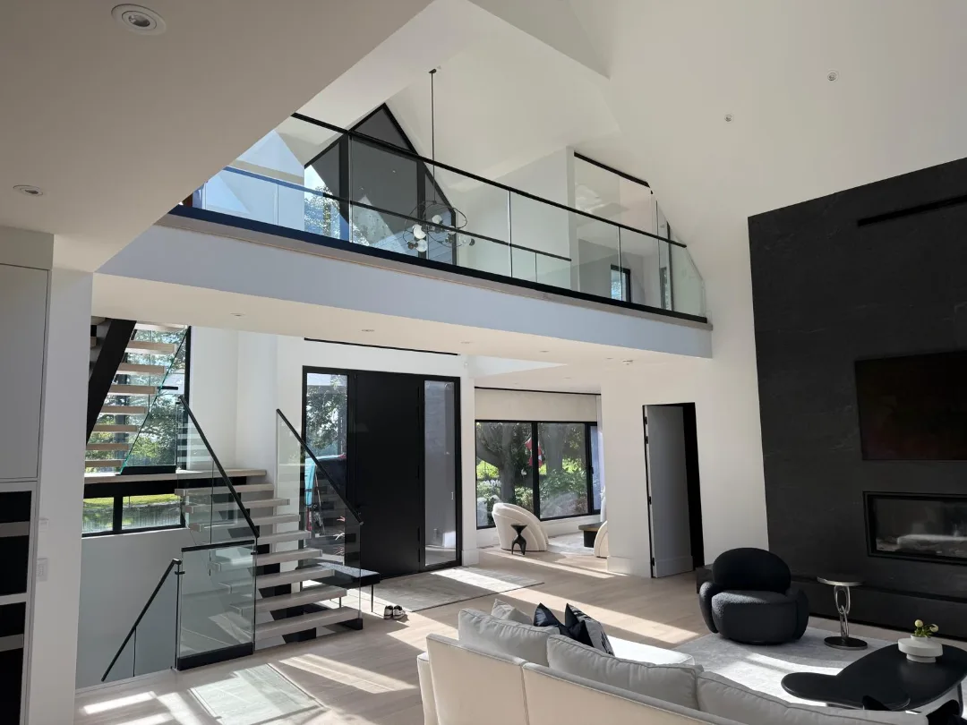 Double-height frameless glass railing with top bar, 12 mm tempered — Toronto