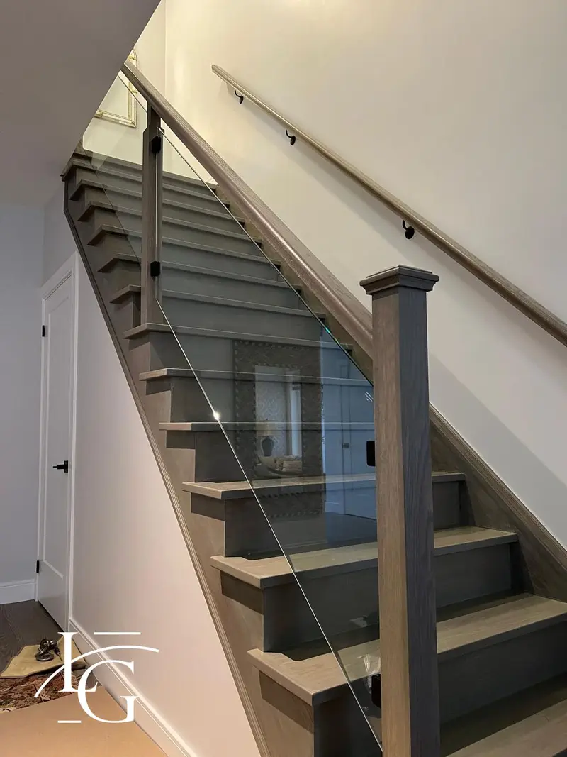 Glass stair railing with wood handrail — Vaughan