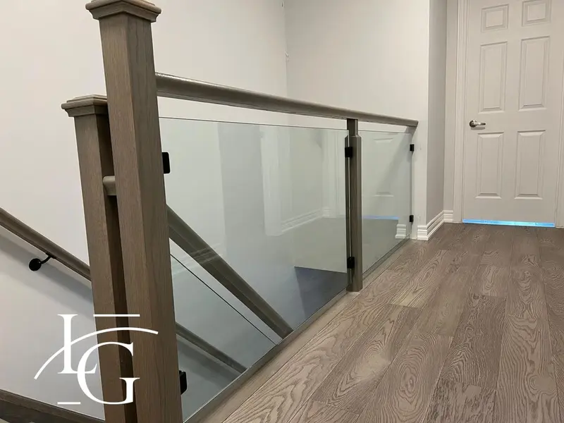 Glass railing with wood posts on a stair landing — Milton