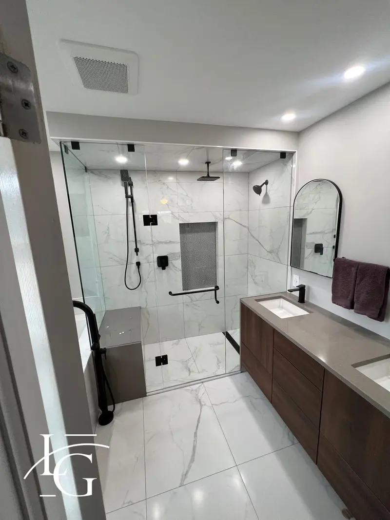 Three-piece frameless shower door in a marble bath, 10 mm — Mississauga