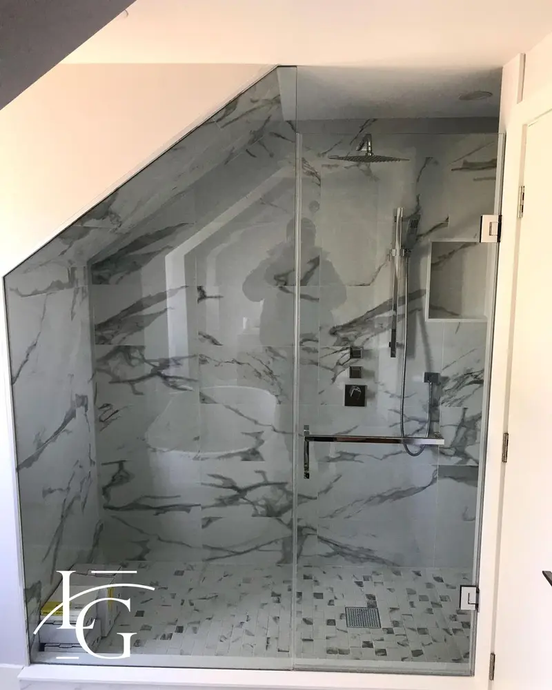 Custom angled shower glass under a sloped ceiling