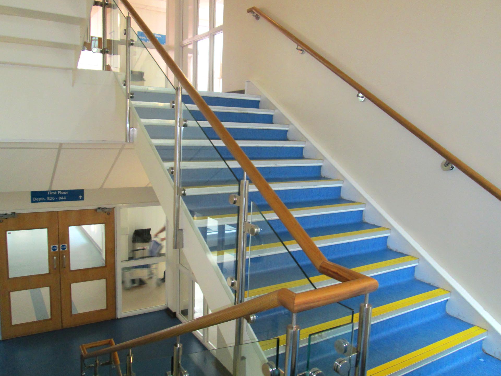 Interior glass railing with wooden handrail — Burlington home