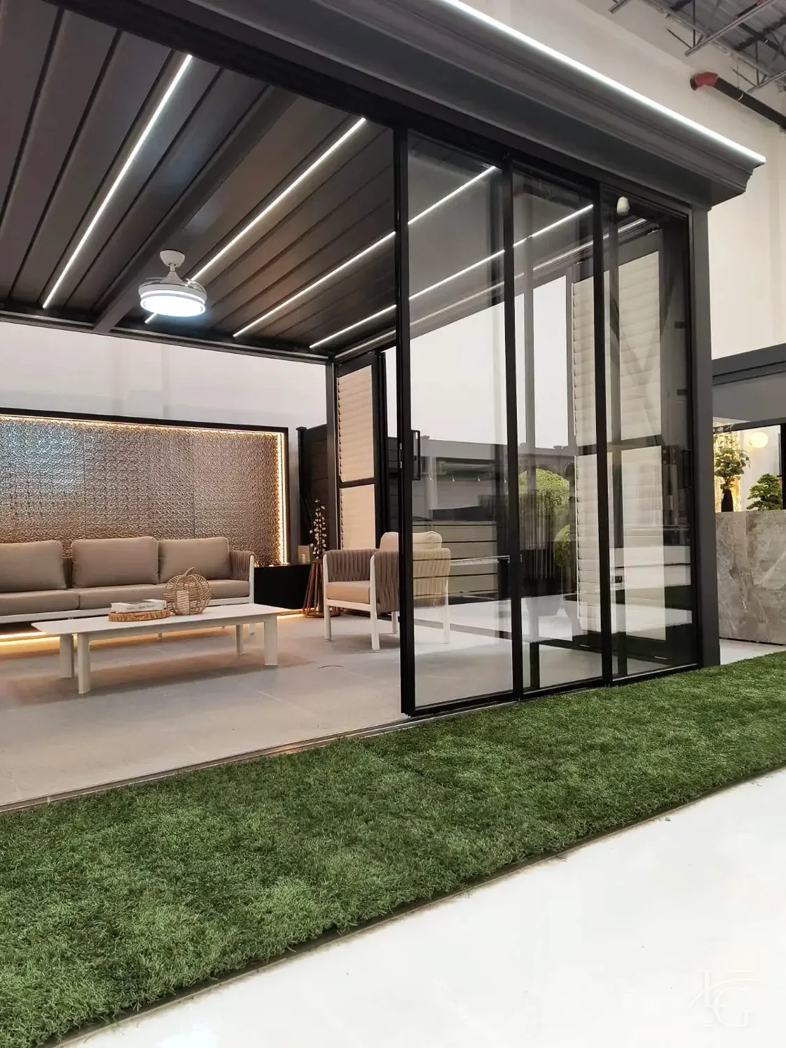 Aluminum louvered pergola with a glass-wall room and a custom outdoor kitchen with a built-in BBQ island