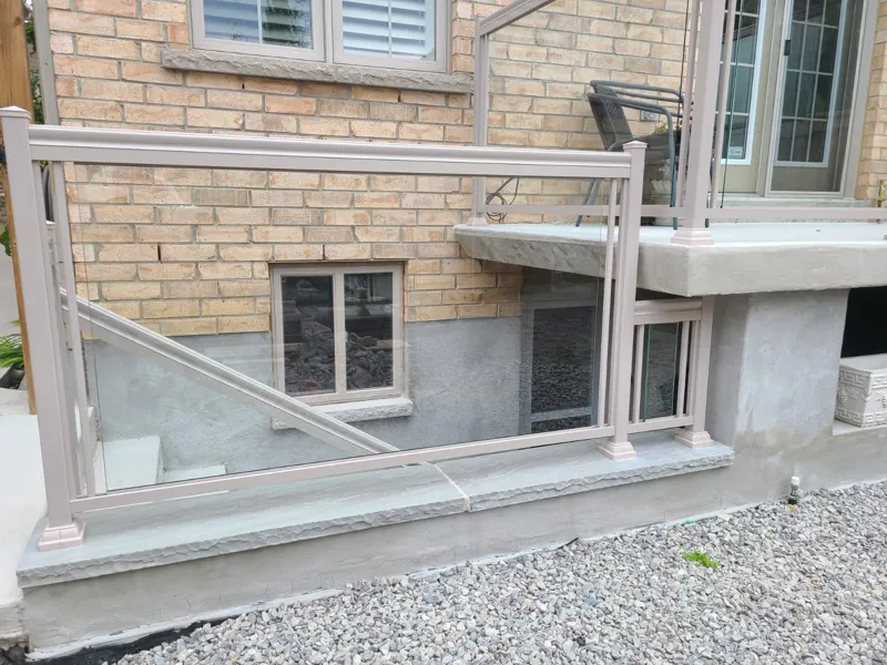 Beige aluminum framed glass railing, model GR1, along a walkout stair