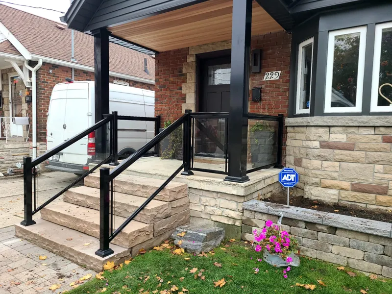 Black aluminum framed glass railing, model GR1, on front entry steps