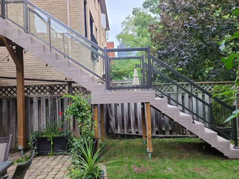 Pewter aluminum framed glass railing, model GR1, with clear glass on a deck stair