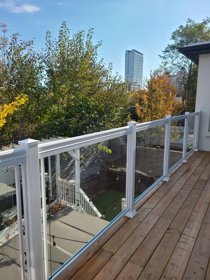 White aluminum framed glass railing, model GR1, on a wood deck