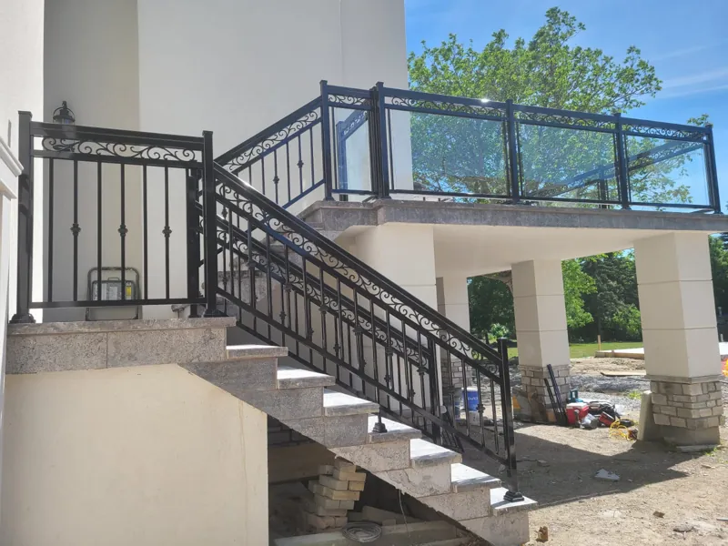 Black aluminum framed glass railing, model GR6, on an exterior stair and upper deck