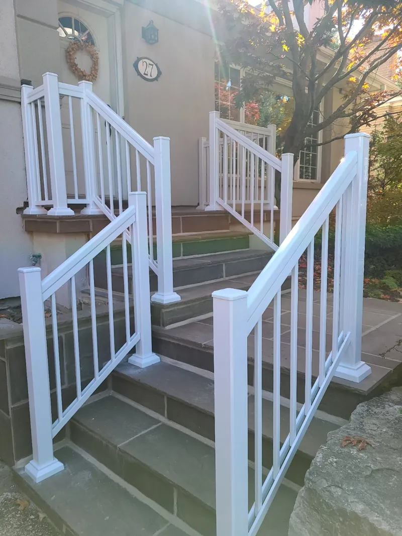 White aluminum picket railing, model R1, on stone entry steps