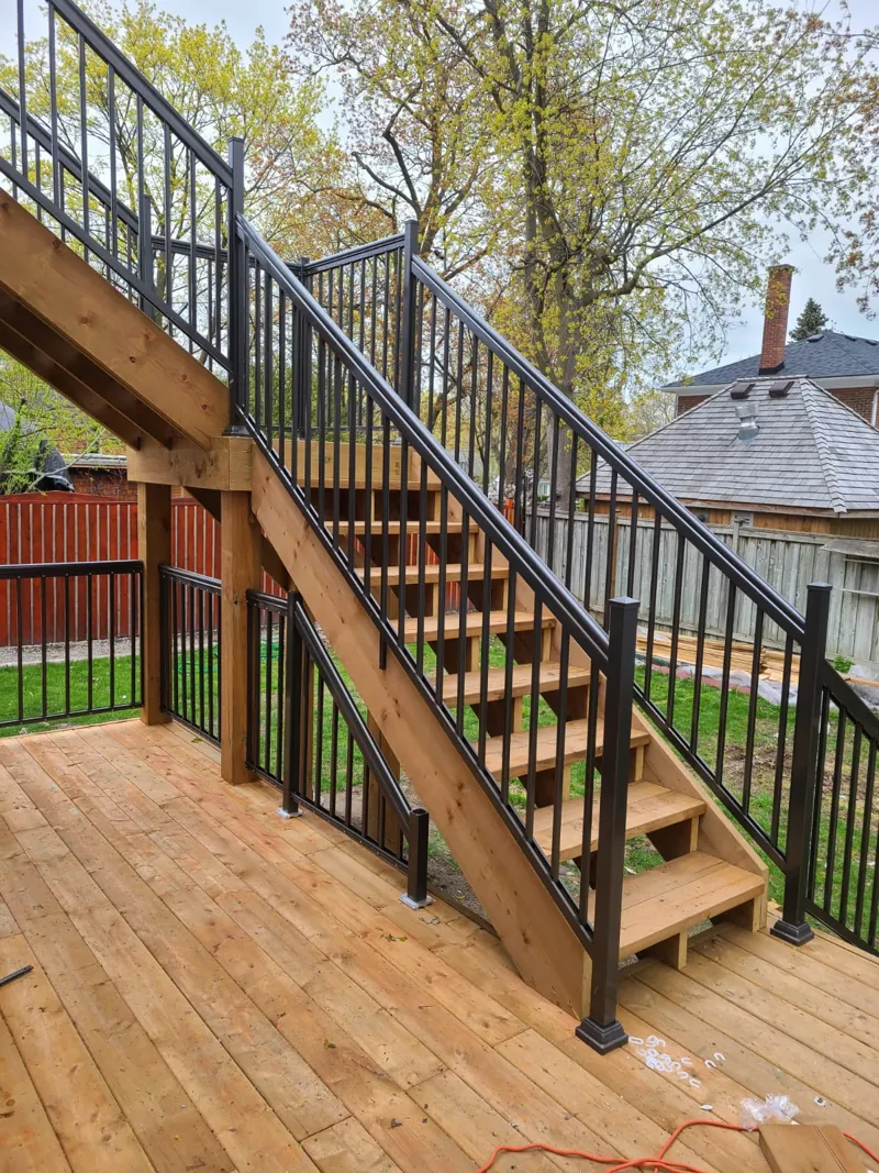 Black aluminum picket railing, model R1, on an exterior wood staircase