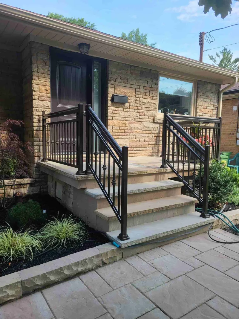 Black aluminum picket railing, model R13, on front entry steps and landing