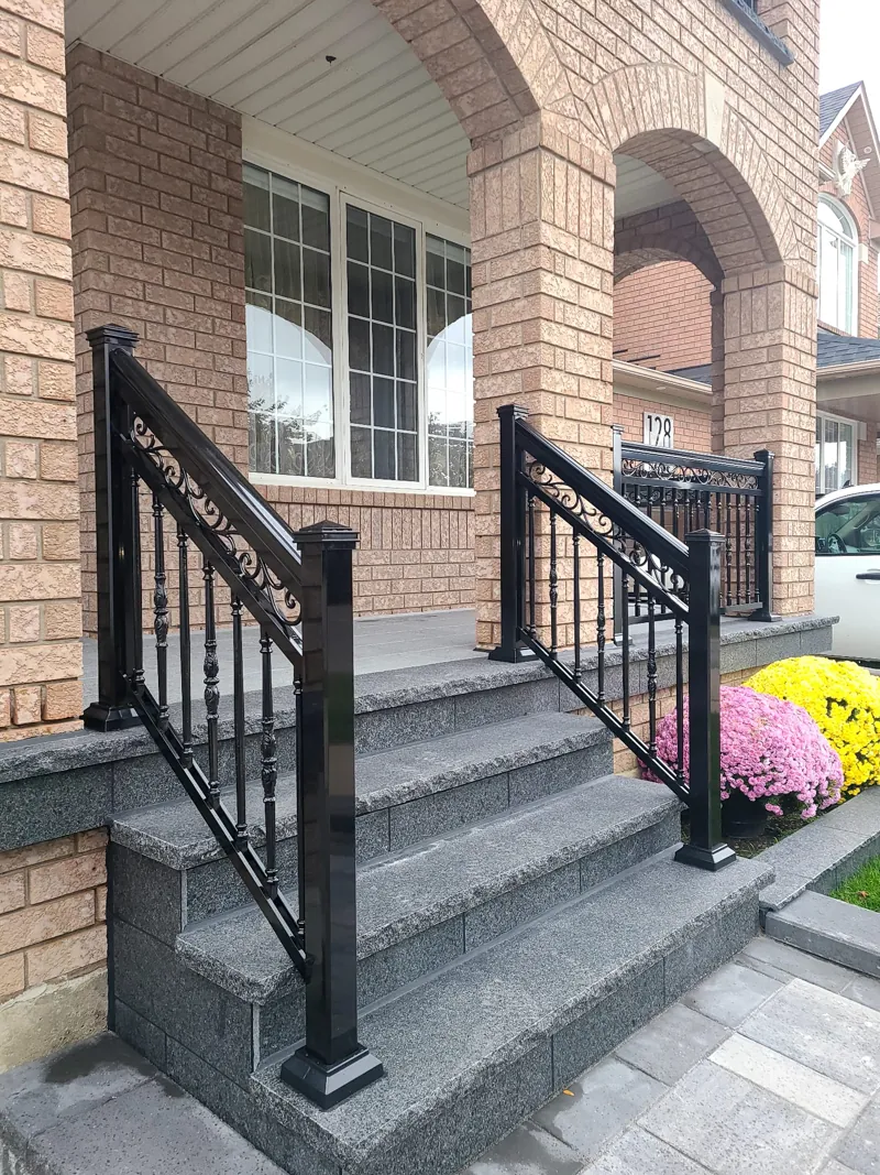 Black aluminum picket railing, model R20, on stone entry steps
