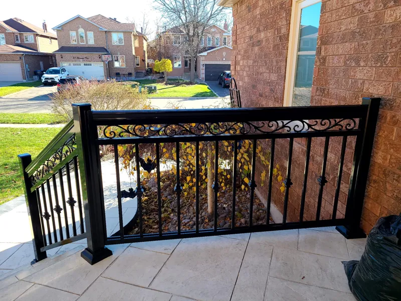 Black aluminum railing with scroll band, model R5, on a front porch