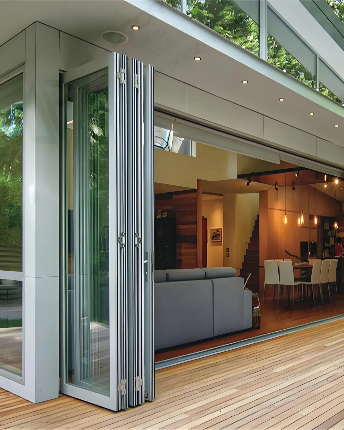 Folding glass wall fully opened, panels stacked to the side