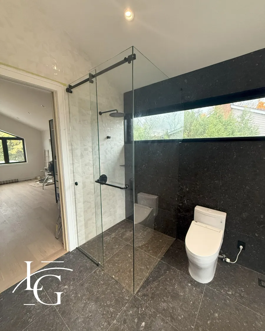 Frameless shower installed by Lux Glass in Burlington, matte black hardware