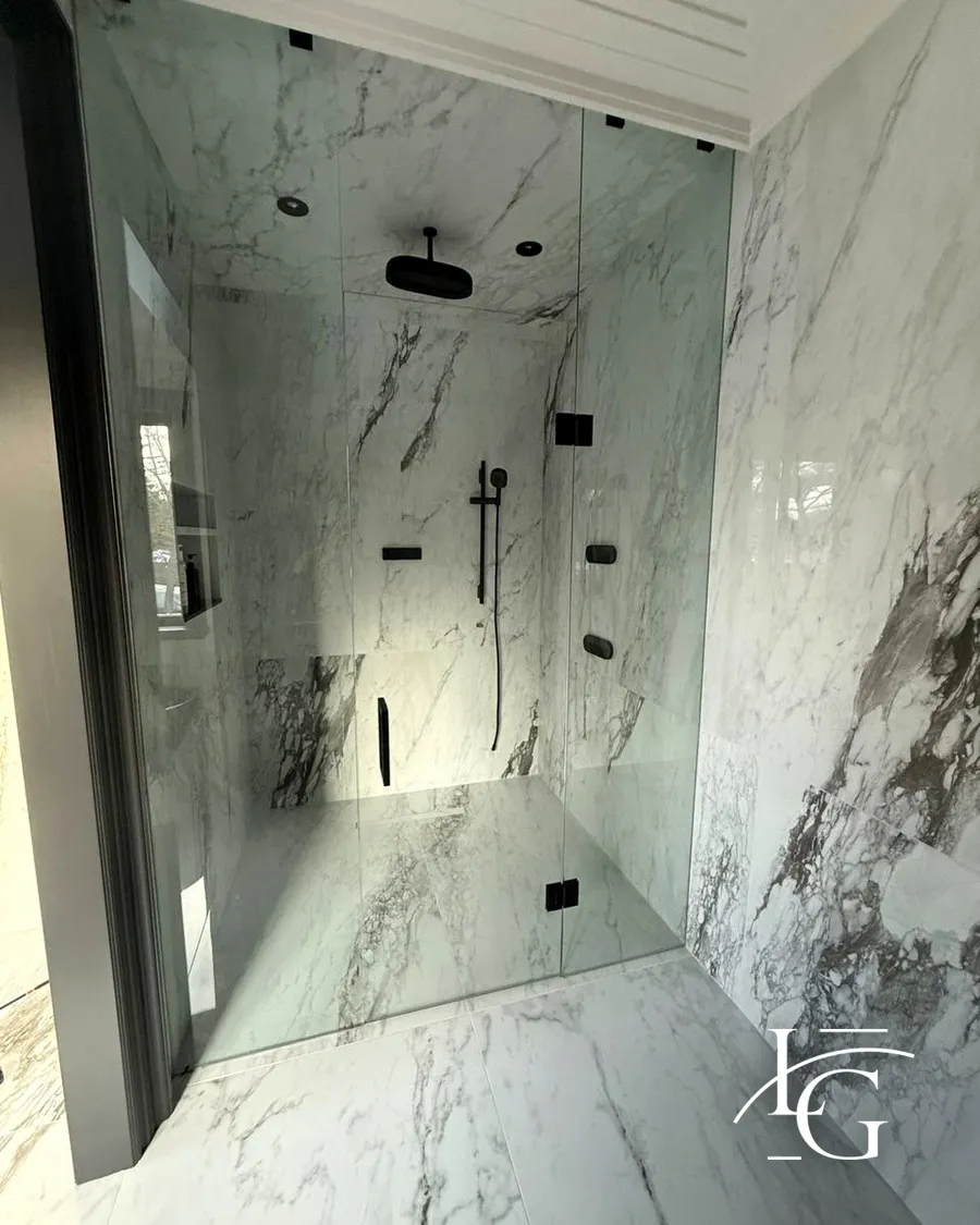 Frameless shower installed by Lux Glass in Oakville, matte black hardware