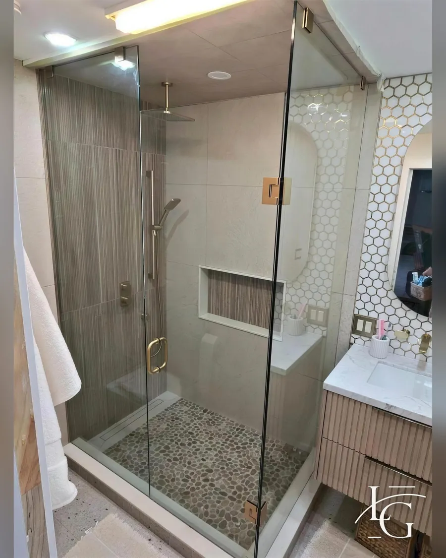 Frameless shower installed by Lux Glass in Burlington, brass and gold hardware
